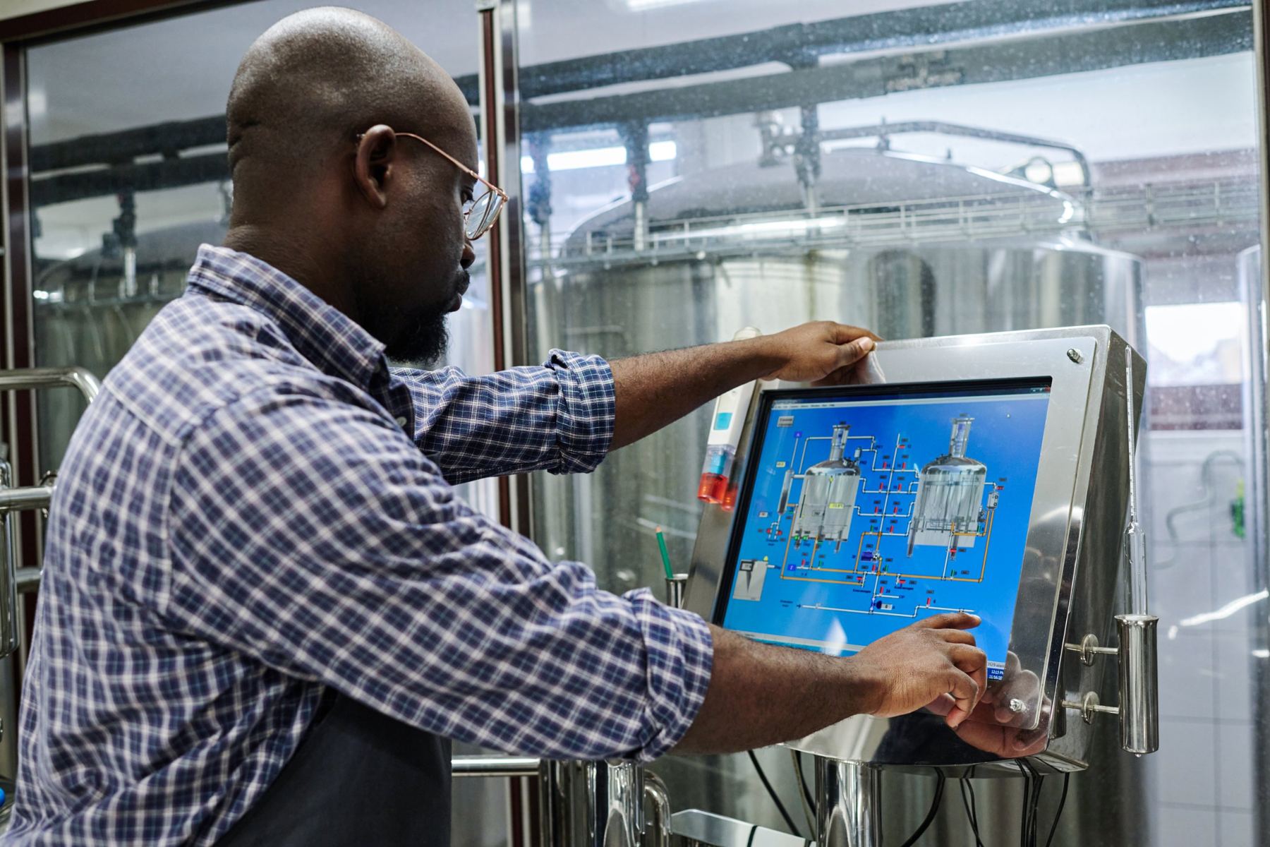 Technician working on a process HMI screen in a beverage plant